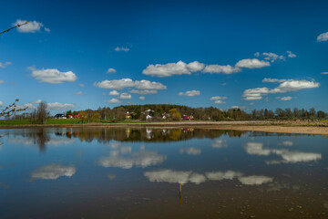 Fototapeta na wymiar Pond with blue water near Rybnicna village in spring sunny day