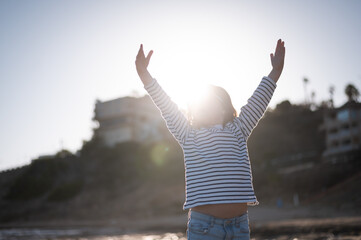 Fototapeta premium Happy girl with namaste hands on beach