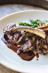 A plate of lamb chops with peas and peas