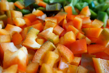 close sweet red bell pepper diced.  side view.  kitchen .  cooking stage.  raw vegetable