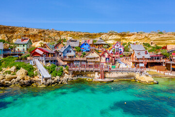 Malta, Il-Mellieha. View of the famous Popeye  village Mellieha and bay on a sunny day - obrazy, fototapety, plakaty