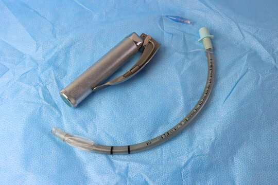 Armored( re-inforced)endotracheal tube and a laryngoscope above a surgical surface