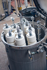 Obraz premium A industrial dyeing machine, raw cotton dye hot heat dip dyeing cotton into various colours for the textile and fashion industry. Raw cotton getting prepared