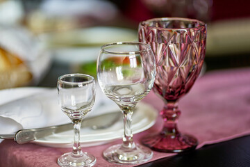 Serving the table with glasses for various drinks.