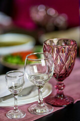 Serving the table with glasses for various drinks.