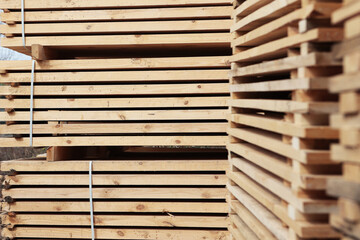 Stacked wooden boards in the woodworking industry. Stacks with pine lumber.Folded edged board.