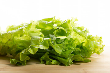 Green salad on a white background.Slicing salad on a board.