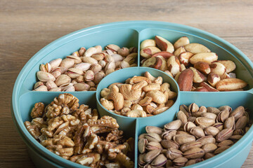 Mix of nuts in a container on a wooden table