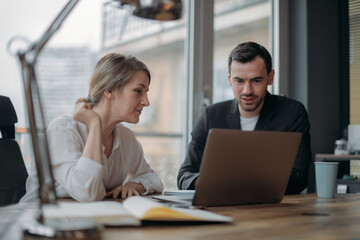 Teamwork in business. Partners are discussing business issues at the table in the office.