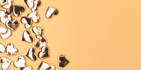 Banner witth golden shiny hearts confetti. Composition with place for text.