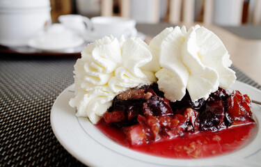 Plum fruit cake with whipped cream and coffee