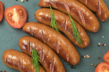 Grilled meat sausages. Fried sausage. Fried anchovies preparing for consumption.