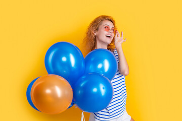 party girl with balloon in sunglasses. happy girl hold helium balloons in studio.