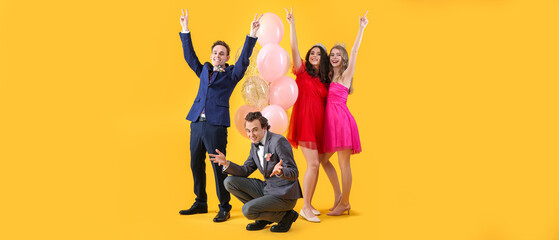 Happy couples dressed for prom on yellow background - obrazy, fototapety, plakaty