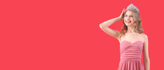 Beautiful young girl in prom dress and tiara on red background with space for text © Pixel-Shot