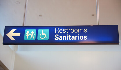 Restroom sign with figures of a girl, guy, and handicap symbol depicts gender and accessibility....