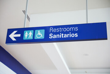 Restroom sign with figures of a girl, guy, and handicap symbol depicts gender and accessibility. The girl and guy figures indicate separate restrooms for men and women