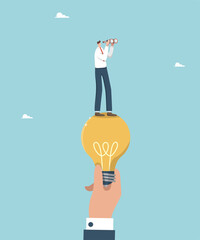 Teamwork and brainstorming, leadership in solving problems and overcoming difficulties, helping to create creative ideas for business, a large hand holding a light bulb with a man looking binoculars.