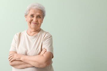 Senior woman on green background