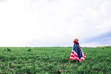 Patriotic Holiday. cute little child girl with American flag. USA celebrate 4th of July enjoying...