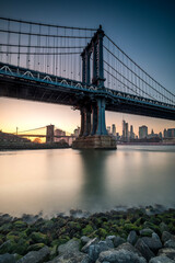 Manhattan Bridge seen from the coast next to the D.U.M.B.O area, during dusk with completely clear skies