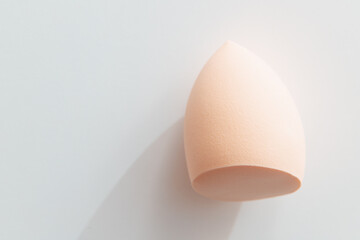 Beauty Blender for Makeup Foundation or cream on white background, sun light