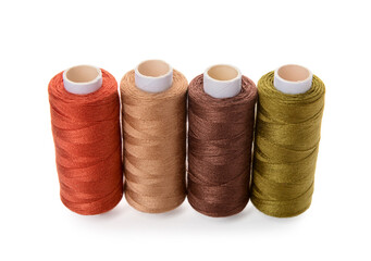 Row of thread spools isolated on white background