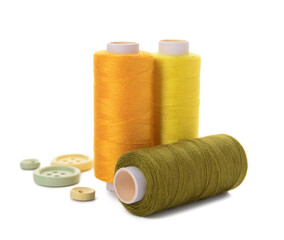 Thread spools and buttons isolated on white background
