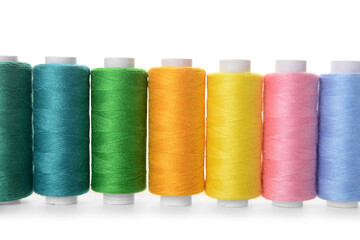 Set of colorful thread spools on white background, closeup