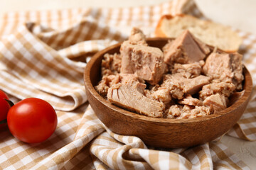 Bowl with delicious canned tuna on crumpled napkin, closeup