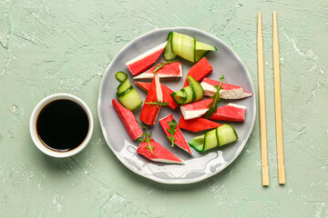 Plate with tasty crab sticks and sauce on light background © Pixel-Shot