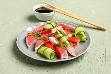 Plate with tasty crab sticks on light background © Pixel-Shot