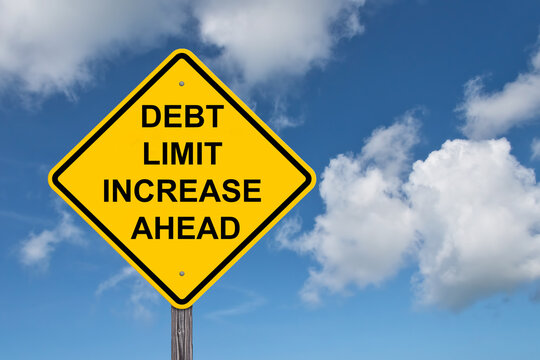 Debt Limit Increase Ahead Caution Sign - Blue Sky Background