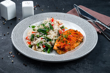 Fried pork with onions, cheese and carrots with rice, green beans and sweet peppers.