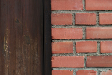 red brick wall with a wooden brown door on the background