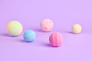 Bath bombs on lilac background