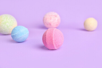 Bath bombs on lilac background, closeup
