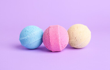 Bath bombs on lilac background