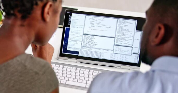African American Coder Using Computer At Desk
