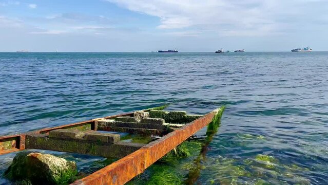 rusty rails go into the blue sea water - stock video