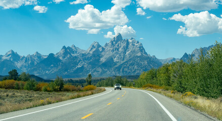 Grand Teton mountain range over the road. Grand Teton National Park, Wyoming, United States.