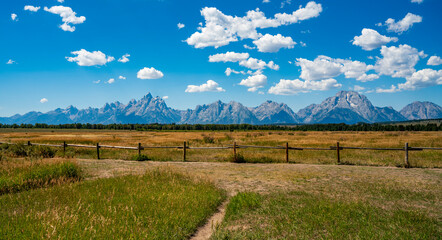 Grand Teton mountain range over the plain with fence in the front. Grand Teton National Park, United States.