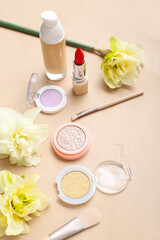 Fototapeta na wymiar Beautiful daffodils with different cosmetics on beige background