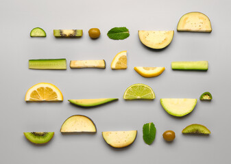 Composition with green fresh fruits and vegetables on grey background