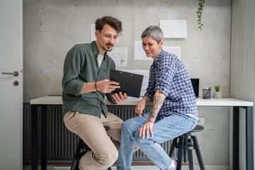 Mature senior Woman and Adult man mother and son Work in Small Office