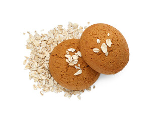 Delicious oatmeal cookies and flakes on white background, top view