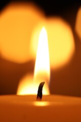 Burning wax candles on blurred background, closeup