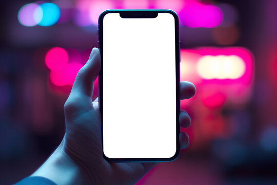 Close-up, hand holding smartphone with empty screen mockup in mid night city with neon lights . Generative ai