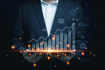 Business, financial, investment concept. A businessman holding tablet on hand with virtual screen...