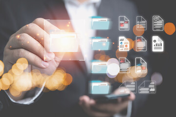 Document management system concept. Electronic files system for corporate enterprise in the future. Businessman touch on folder documents for management paperwork, paperless by using electronic files.